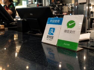 Alipay and WeChat Pay signs on counter
