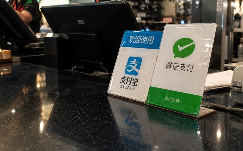 Alipay and WeChat Pay signs on counter